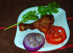 A picture of Tandoori Chicken in Microwave Oven.