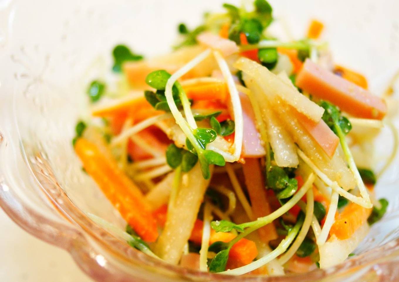 Colorful daikon and carrot salad with sesame seeds