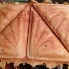 A picture of Cheese scones on a electric sandwich maker.