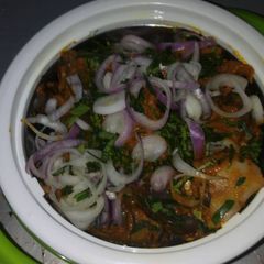 A picture of Isi ewu (goat head) in potash sauce.