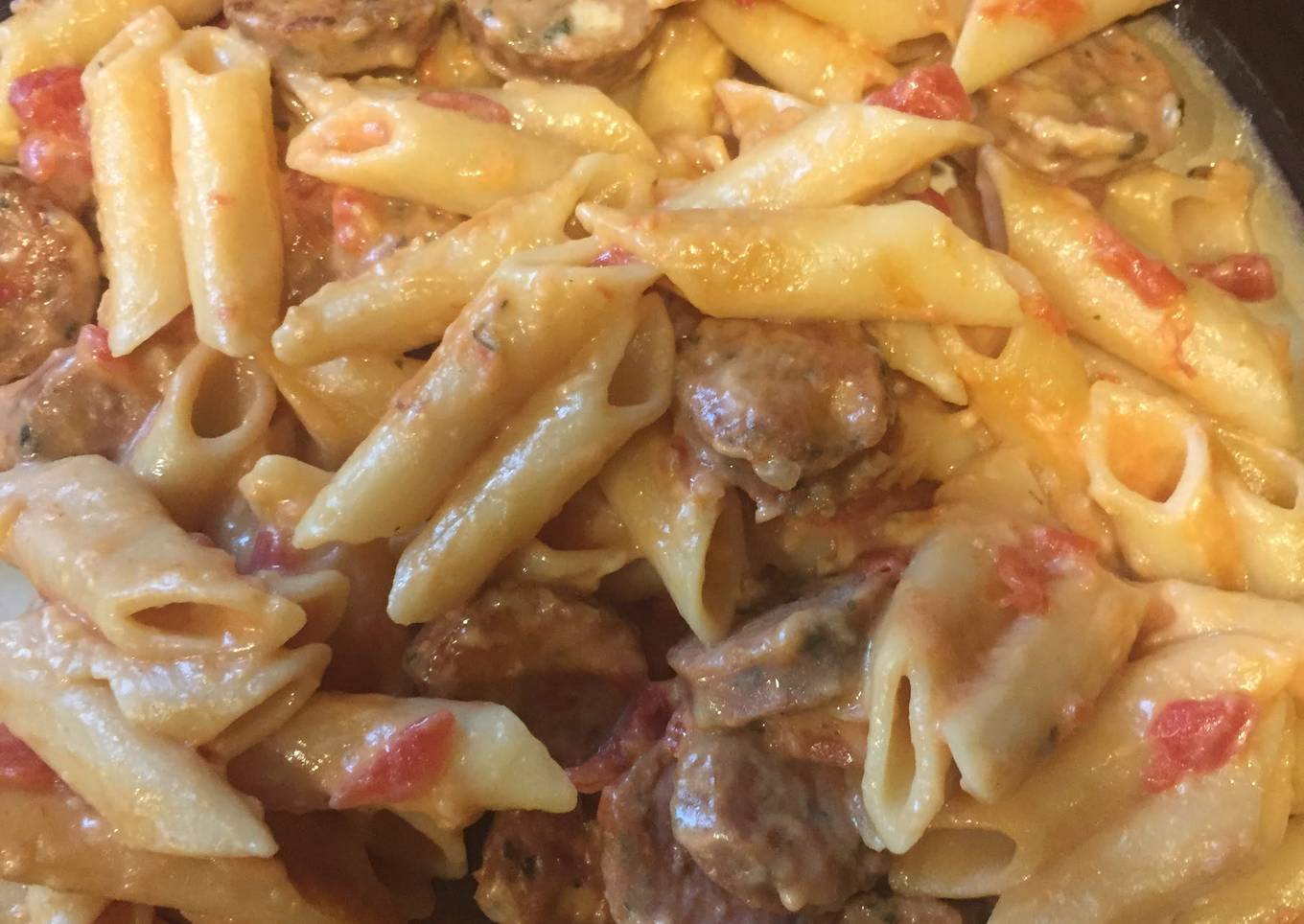 A plate of sausage and cheese macaroni