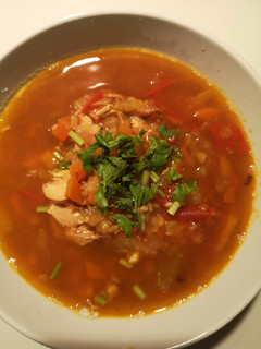 A picture of Lentil soup with shredded roast chicken.