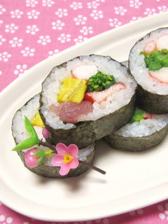 A picture of Doll's Festival Seafood Futomaki Sushi Rolls with Nanohana.