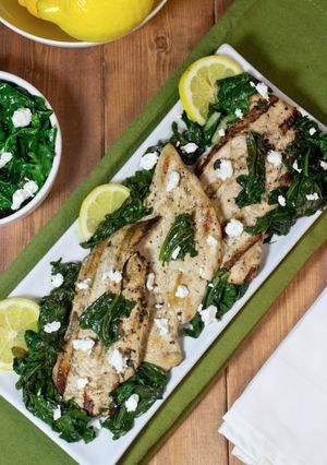 A picture of Marinated grilled chicken with sauteed kale and spinach.