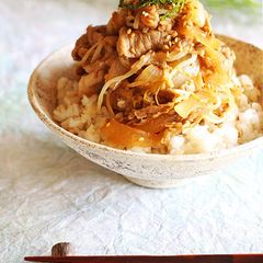 A picture of Sustaining Pork Dish with a Whole Apple.