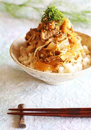 A picture of Sustaining Pork Dish with a Whole Apple.