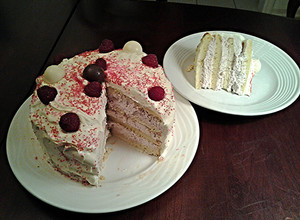 A picture of White Butter Cake layered with Raspberry Cream with a White Chocolate Frosting.