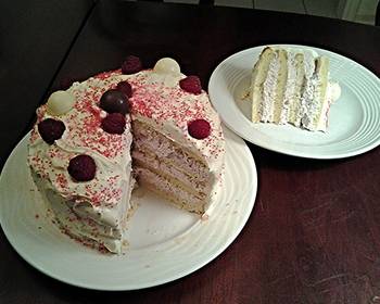 Best Recipe White Butter Cake layered with Raspberry Cream with a White Chocolate Frosting Delicious and Healthy