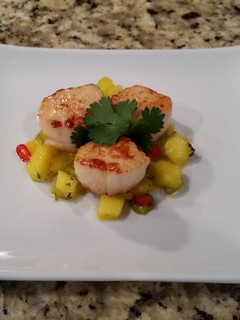 A picture of Seared Scallops with a spicy Mango salsa.
