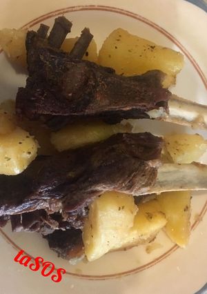 A picture of Lamb Ribs with Potatoes in a Dutch Oven.