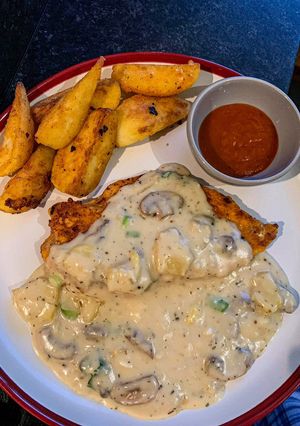 A picture of Chicken fillet with mushroom and pineapple creamy sauce.
