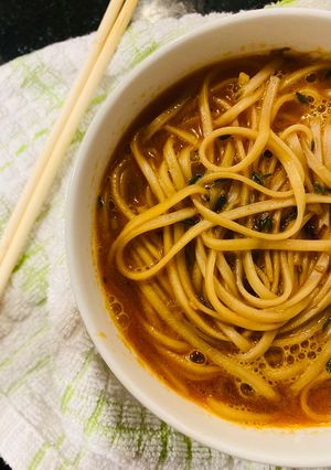 A picture of Prawn head and noodle soup.