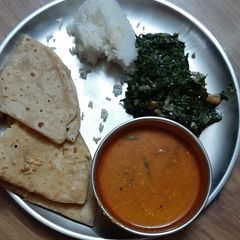 Puran poli with katachi amati A picture of Puran poli with katachi amati.
