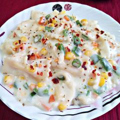 A picture of Pasta in white sauce.