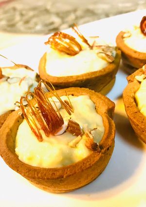 A picture of Kheer tart cups with sugar spiral.