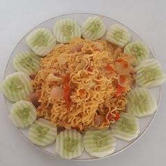 Indo Mie surrounded with cocumber A picture of Indo Mie surrounded with cocumber.