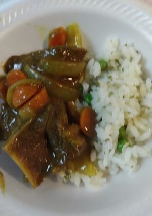 A picture of Curried Goat with Parsley Pea Rice.