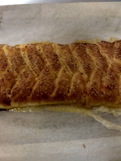 Una foto de Trenza de hojaldre rellena de queso crema, jamón de york y cheddar