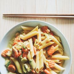 A picture of Penne pasta filled with milk,.