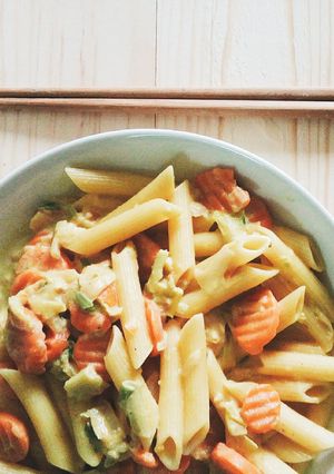 A picture of Penne pasta filled with milk,.