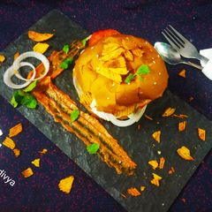 A picture of Chickpea Aloo tikki lays burger.