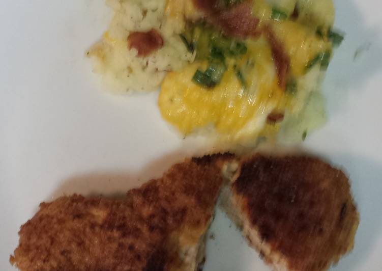 Breaded pork loin chops with a side of mashed potatoes topped with bacon, cheese,green onion Breaded pork loin chops with a side of mashed potatoes topped with bacon, cheese,green onion