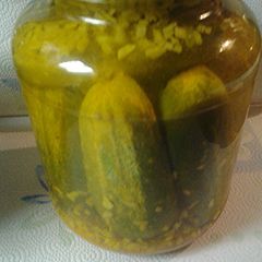 A picture of Whole Pickles with onions.