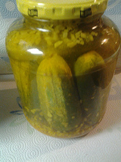 A picture of Whole Pickles with onions.