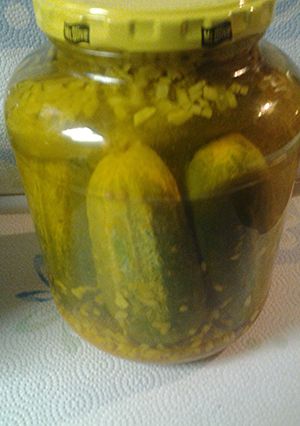 A picture of Whole Pickles with onions.
