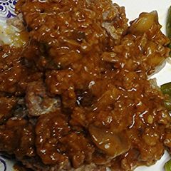 A picture of Mushrooms stuffed in meat loaf.