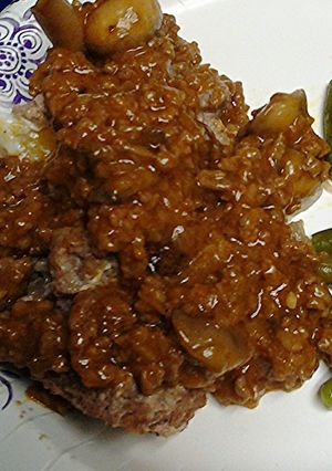 A picture of Mushrooms stuffed in meat loaf.