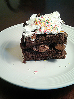 A picture of Chocolate Sheet Cake with Whipped cream Toppings.