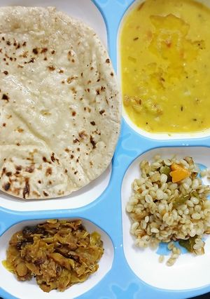 A picture of Toor Dal/Barley Khichdi and a Cabbage.