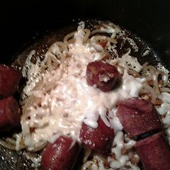 A picture of Udon noodles cheese and sausage.