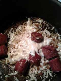 A picture of Udon noodles cheese and sausage.