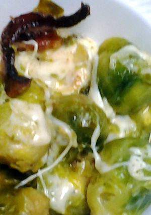 A picture of Brussel sprouts with bacon and cheese.