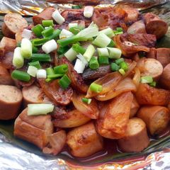 A picture of Baked Spicy Sausage In Banana Leaf Wrap.