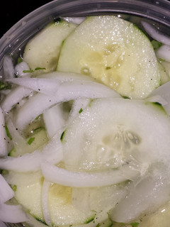 A picture of Cucumbers & onions.