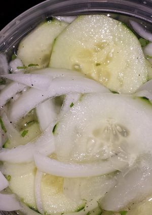 A picture of Cucumbers & onions.