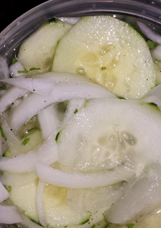A picture of Cucumbers & onions.