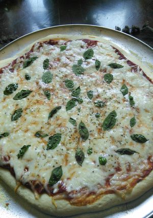 A picture of Pizza dough with beer.