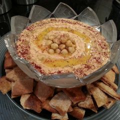 A picture of Roasted Red Pepper & Roasted Garlic Hummus w/ Whole Wheat Pita Chips.