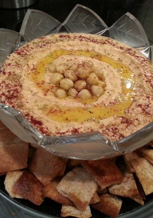 A picture of Roasted Red Pepper & Roasted Garlic Hummus w/ Whole Wheat Pita Chips.