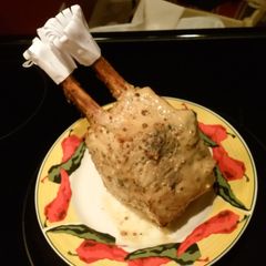 A picture of 1/2 crown roast pork with rosemary.