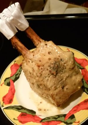 A picture of 1/2 crown roast pork with rosemary.