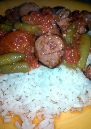 A picture of stewed tomatoes and sausage.