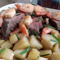 A picture of shrimp roast with greek seasoned potatoes.