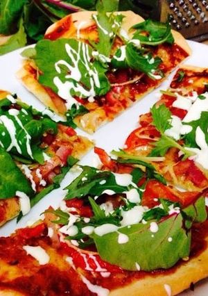 A picture of Cheese & Bacon Pizza with Leafy Greens.