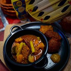 A picture of Macher Dimer Borar Tok Jhol (Fish Roe Fritters in Tangy Curry).