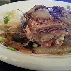 A picture of Double Cut Pork Chop Stuffed with Prosciutto & Italian Cheese.